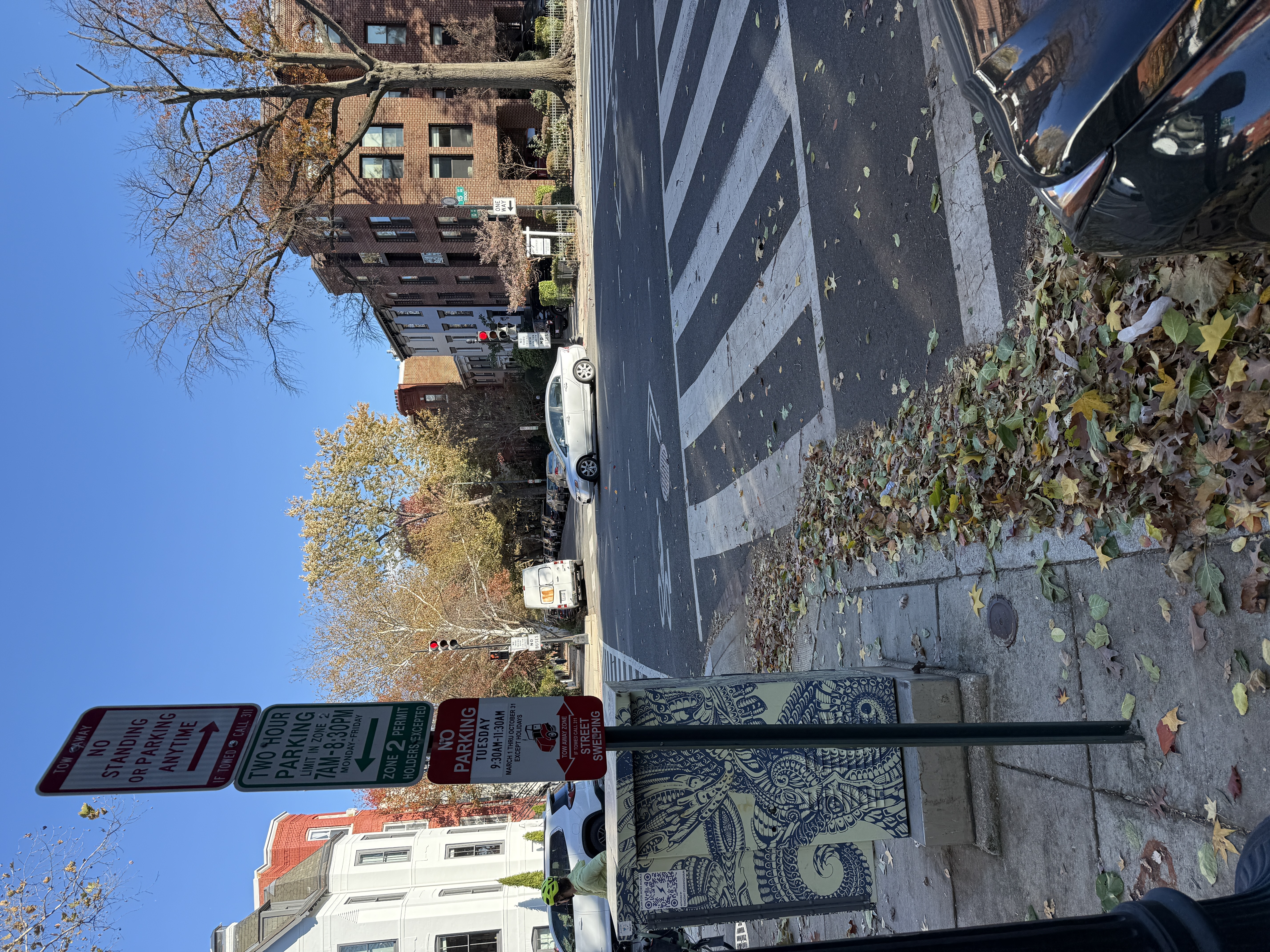 Stack of NO STANDING ANY TIME, 2-HOUR, and NO PARKING signs on a single pole on 15th St NW near Logan Circle. The signage authorizes parking right up against the crosswalk -- DDOT is creating the daylighting violation through its own sign placement.
